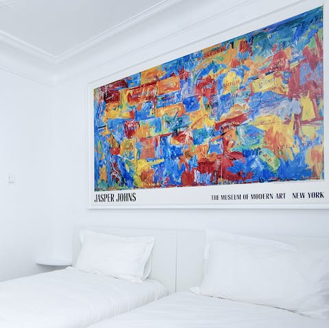 Appreciate the vibrant art work that brings life to the minimal interiors throughout the home