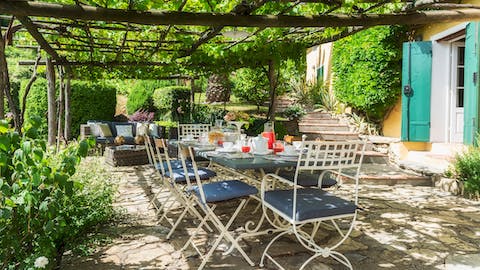 Dine alfresco under the vine-covered pergola