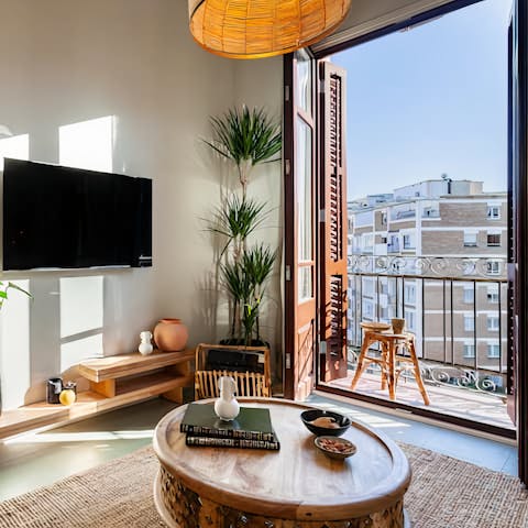 Step out onto the balcony to watch the bustling city below