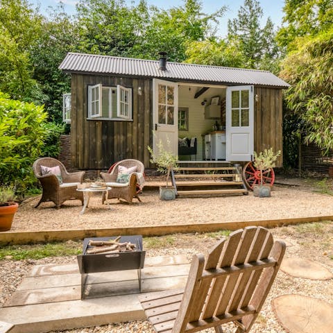 Light the fire pit and savour the magic of outdoor living room