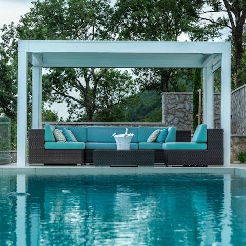 Relax in the shaded terrace by the pool, on comfy sofas with some cold drinks