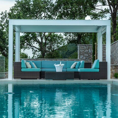 Relax in the shaded terrace by the pool, on comfy sofas with some cold drinks