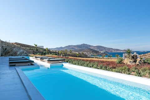 Plunge into the pool while the Aegean coastline stretches out ahead