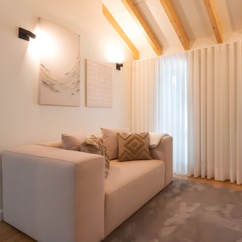 Kick back with a glass of Portuguese wine in the beamed living area