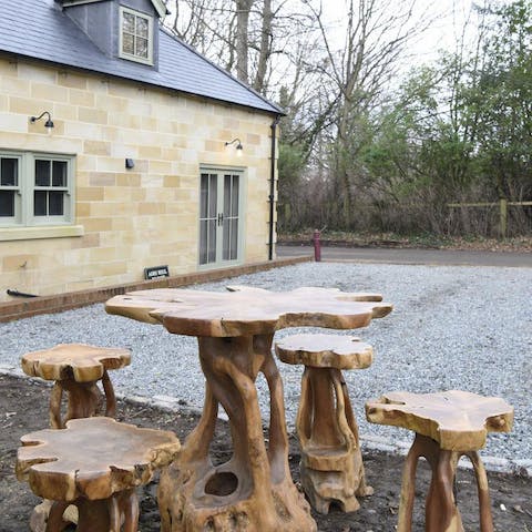 Enjoy your morning coffee at the hand-carved table and chairs outside