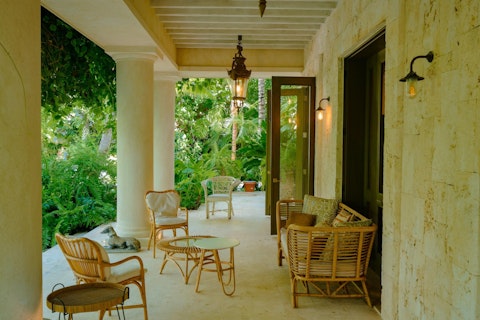 Settle into rattan seating in a shaded corner alive with birdsong and rustling palms