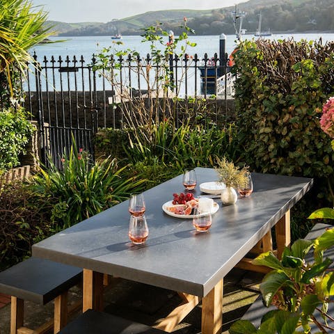 Gather around the dining table for dinner overlooking the water