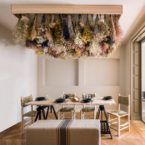Host a festive dinner party underneath the stunning floral artwork