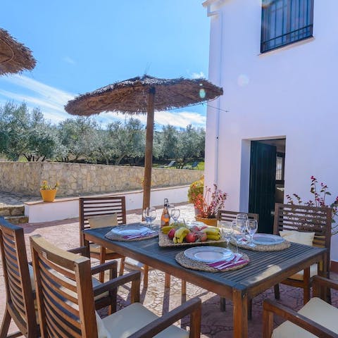 Dine alfresco on the rustic stone courtyard as the sun sets over the mountains