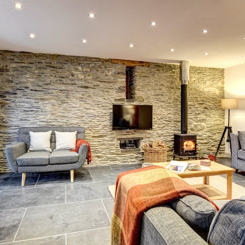 Curl up by the fireplace in the cosy living room after a day of adventure