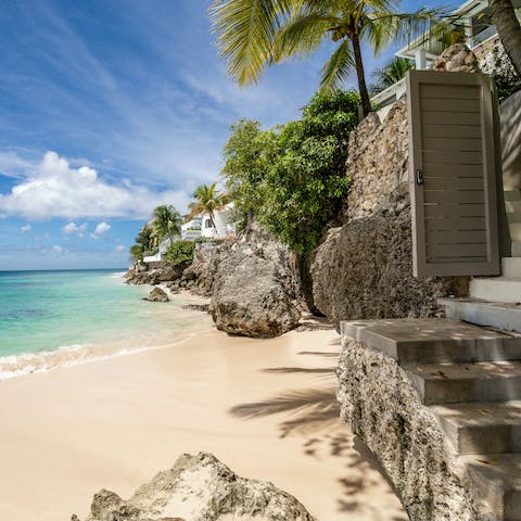 Climb down the steps from your villa onto the white powdered sands