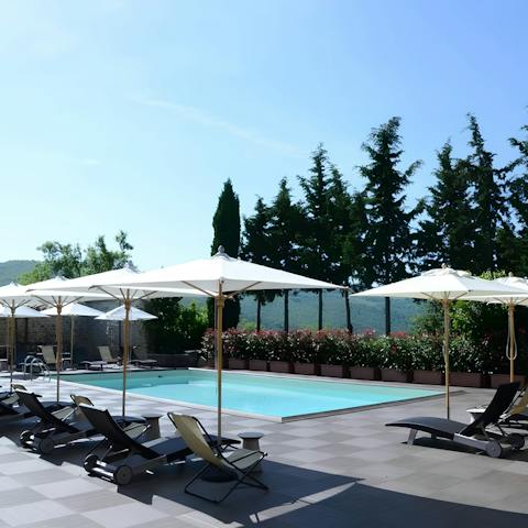 Relax by the communal outdoor pool with a good book