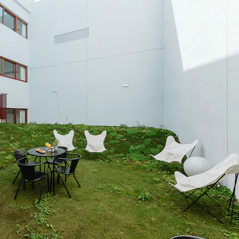 Grab a cup of freshly-brewed coffee to enjoy in the shared mossy garden