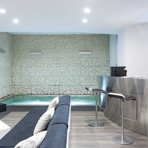 Dip into the unique indoor pool – the home's bar is right there for refreshments