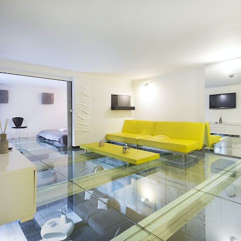 Wave at your friends through the glass ceiling between the bedroom and the living room