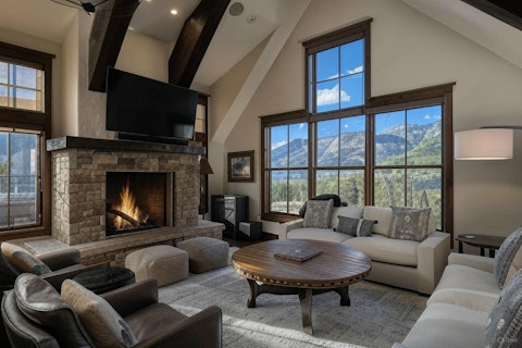 Warm up by the fire as mountain peaks fill the windows
