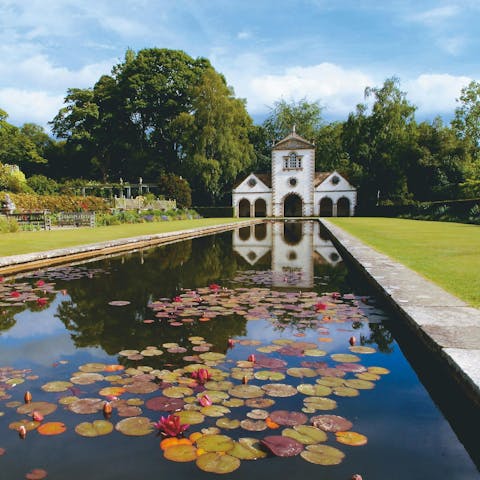 Follow paths through the grounds of the private estate