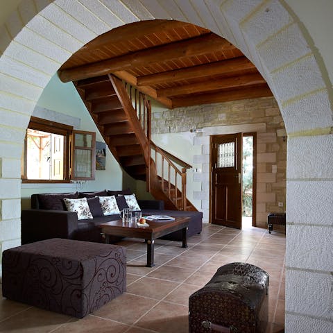 Admire the rustic, traditional elements of the living space with its wooden ceilings