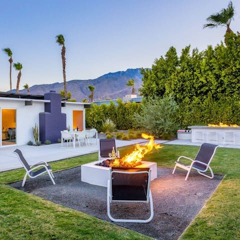 Toast marshmallows around the fire pit as the sun sets behind the mountains