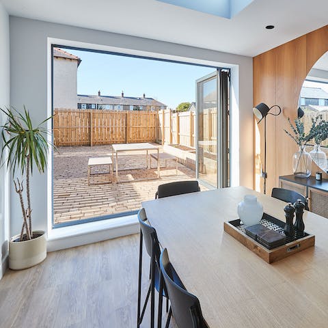 Slide back the large bi-fold doors and let the sunshine in