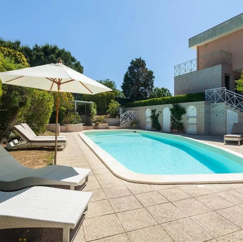 Take it easy at home and spend your downtime sunbathing poolside