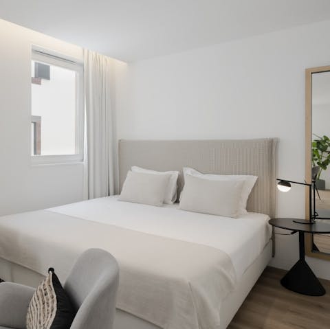 Relax and recover after a long day on this luxurious bed with natural lighting