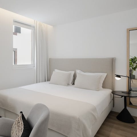 Relax and recover after a long day on this luxurious bed with natural lighting