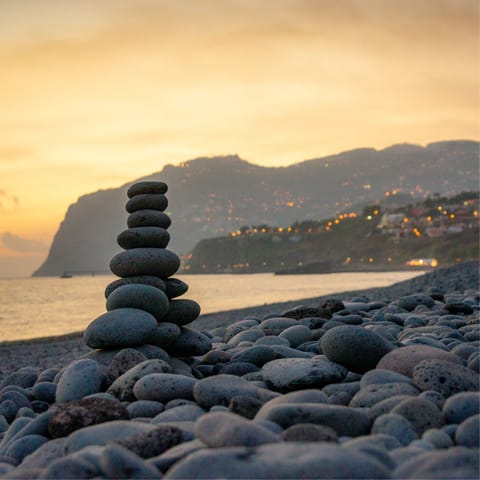 Take an evening walk along the beach with stunning views of the dramatic coastline