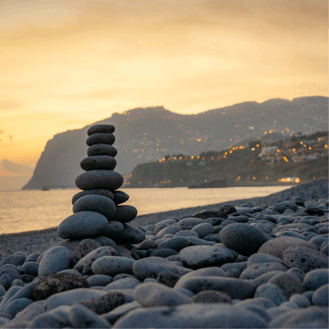 Take an evening walk along the beach with stunning views of the dramatic coastline