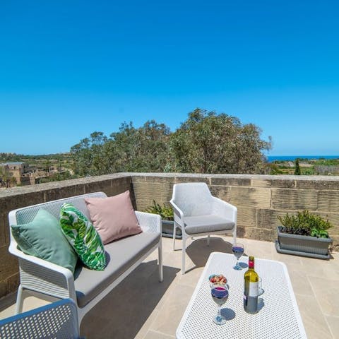 Relax with a glass of wine on the balcony