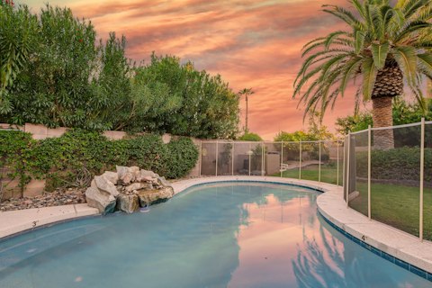 Swim as the Arizona sky turns pink above the palms