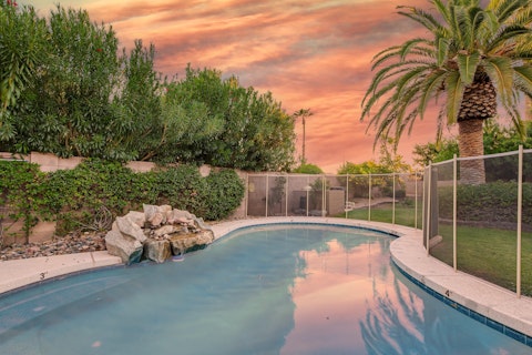 Swim as the Arizona sky turns pink above the palms