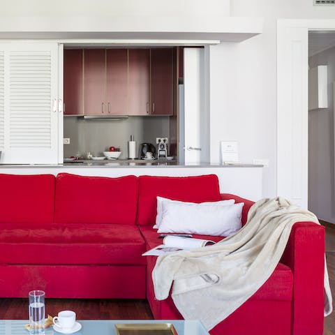 Open some Spanish wine and stretch out on the bright red sofa