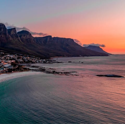 Stroll along Camps Bay Beach at sunset, it's a ten-minute walk away