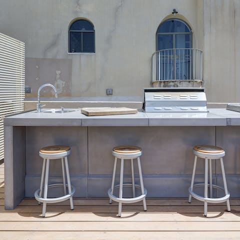 Sip a glass of wine at the bar as the barbecue sizzles away