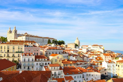 Explore Alfama's labyrinthine medieval streets and vibrant fado houses, a ten-minute walk