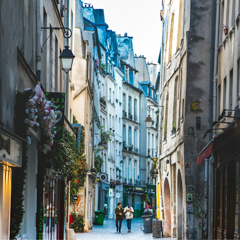 Explore bars and boutiques in lively Le Marais, thirty-minute walk away