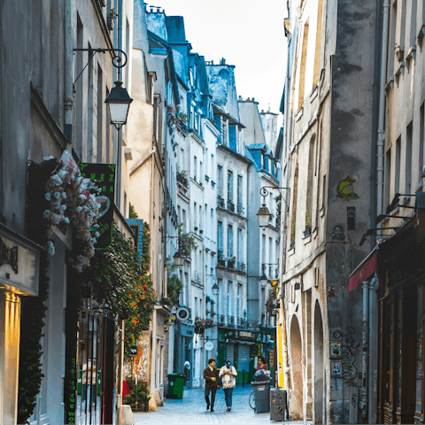 Explore bars and boutiques in lively Le Marais, thirty-minute walk away
