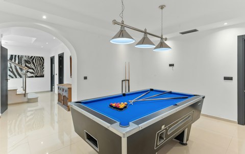Shoot pool in the basement games room
