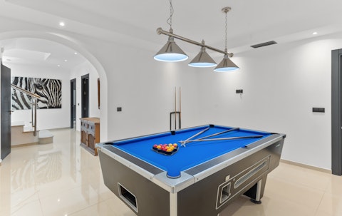 Shoot pool in the basement games room
