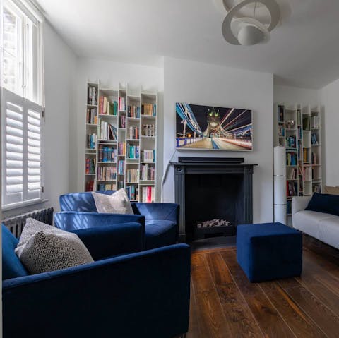 Curl up with a glass of wine on the royal blue fireside armchairs