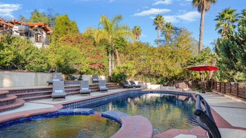 Stretch out on a sun lounger beside the tiled pool