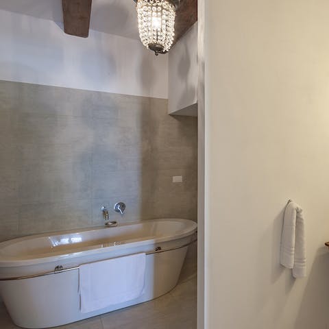 Close your eyes and sink back into warm water in the freestanding bathtub