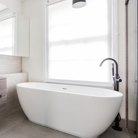 Soak in the freestanding bathtub