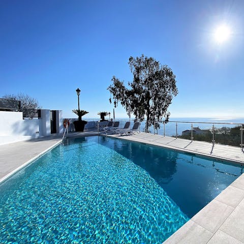 Splash about in the communal pool after sunbathing on a lounger