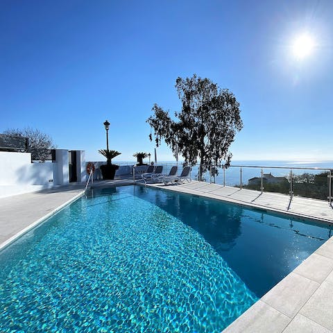 Splash about in the communal pool after sunbathing on a lounger