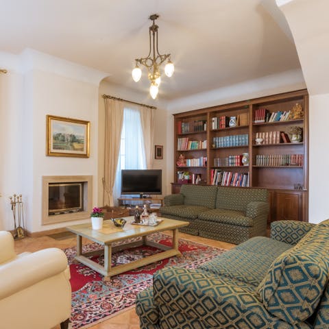 Curl up by the fireplace with a book from the library or a hot drink on a cosy evening