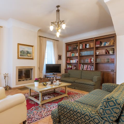 Curl up by the fireplace with a book from the library or a hot drink on a cosy evening