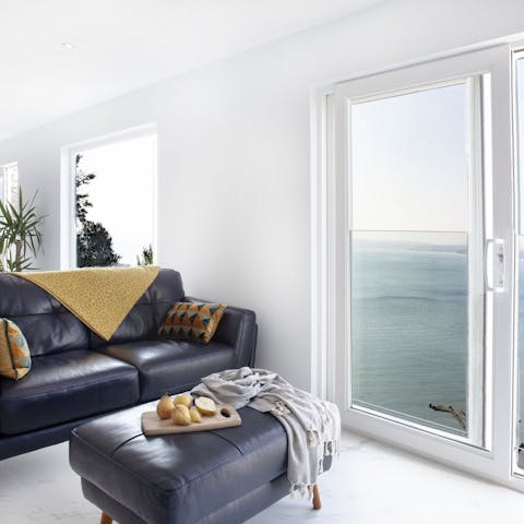 Get comfy in the stylish living room with those stunning sea views to be admired