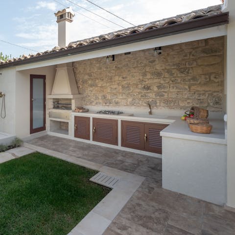 Fire up the barbecue in the outdoor kitchen